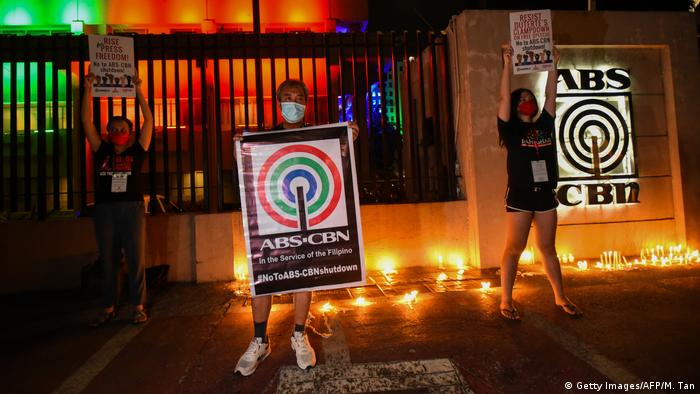 Hours before the station aired its final news broadcast, people gathered outside the ABS-CBN headquarters in the capital of Manila, lighting candles and holding protest signs