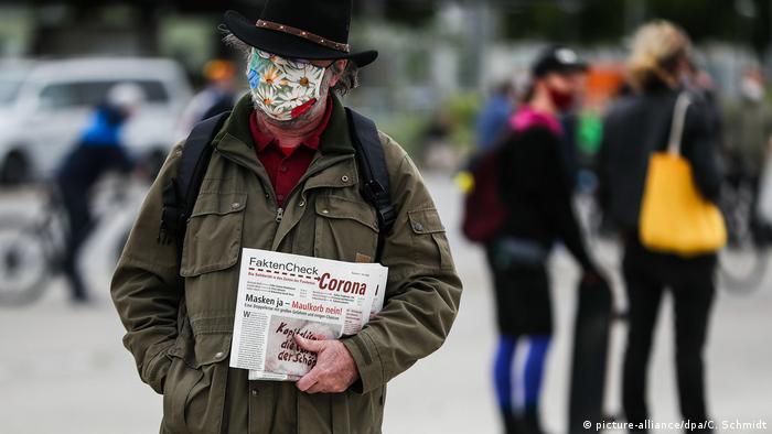A protester in Stuttgart wears a mask
