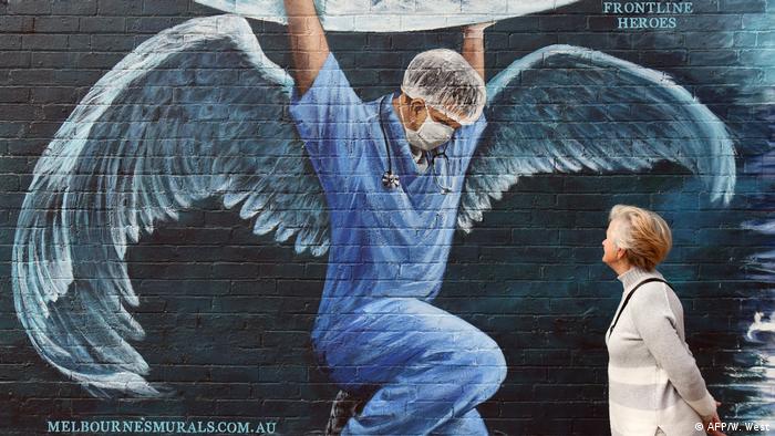 Una mujer observa un mural hecho en honor a los trabajadores de la salud, en Melbourne, Australia (12.05.2020)