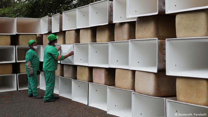 Men prepare to install new spaces for coffins at the Sao Pedro municipal cemetery
