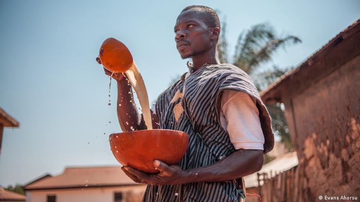 A man prepared a peace drink in a gourd