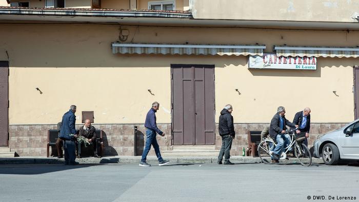 Men walking in downtown Casal Di Principe