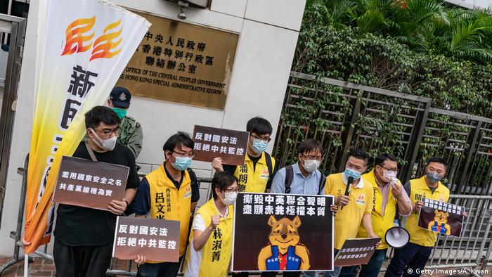 Pro-democracy supporters hold placards and shout slogans as they take part in a rally outside of Chineses Liaison Office on May 24, 2020 (Getty Images/A. Kwan)