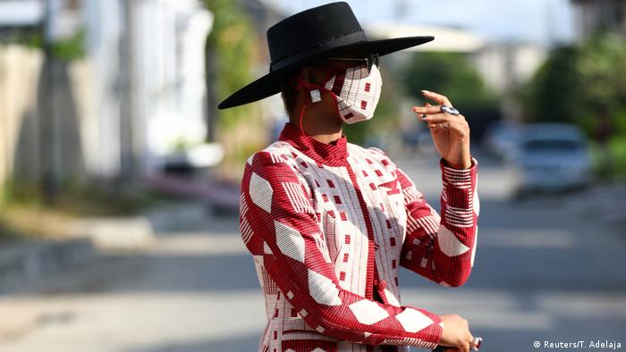 Nigerian fashion influencer Angel Obasi showcases her red and white face mask with matching clothes