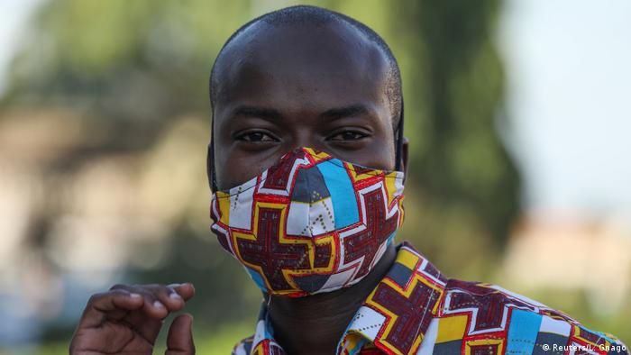 Ivorian designer Arthur Bella N'guessan wears a face mask with color matching his clothes