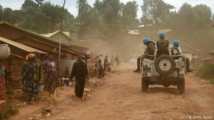 UN peacekeepers ride on a military vehicle in Ituri Province, DRC