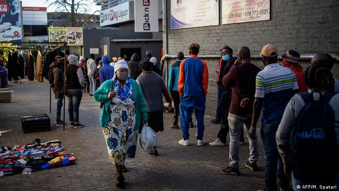 Customers queue outside a liquor shop in Soweto, Johannesburg (AFP/M. Spatari)
