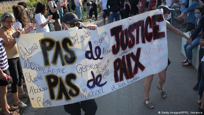 French protesters hold a banner reading No justice, no peace