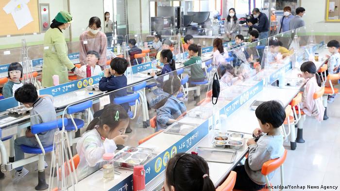 Transparent dividers installed at a primary school cafeteria in Chuncheon, South Korea. The Education Ministry said that 519 schools have been forced to go back to remote learning, as government guidelines direct that all students and staff members have to return to distance learning if an infection is confirmed. 