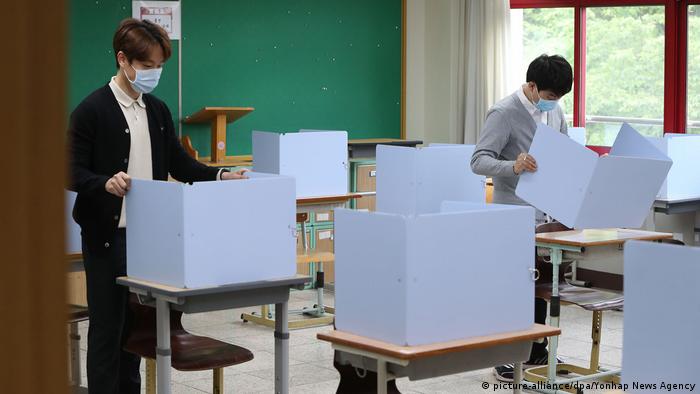 Teachers check partition walls installed to ensure students' safety as they return to classrooms in Daegu, South Korea. In late February, the city of Daegu reported the first large coronavirus outbreak outside of China, resulting in a huge spike in South Korea's COVID-19 infections.