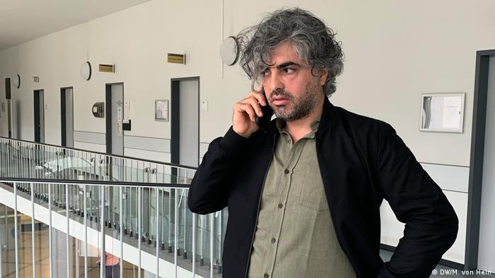 Film director Feras Fayyad talks on his phone