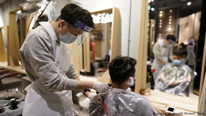 A barber cuts a man's hair in Kuala Lumpur 