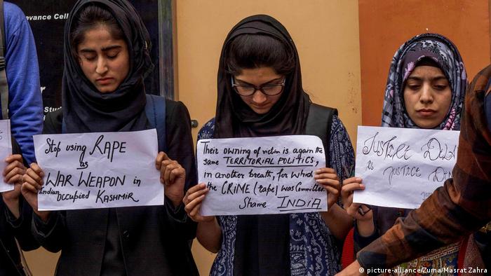 Kashmiri student protesters hold placards during a protest against the rape and murder of a eight year old Muslim girl in Srinagar