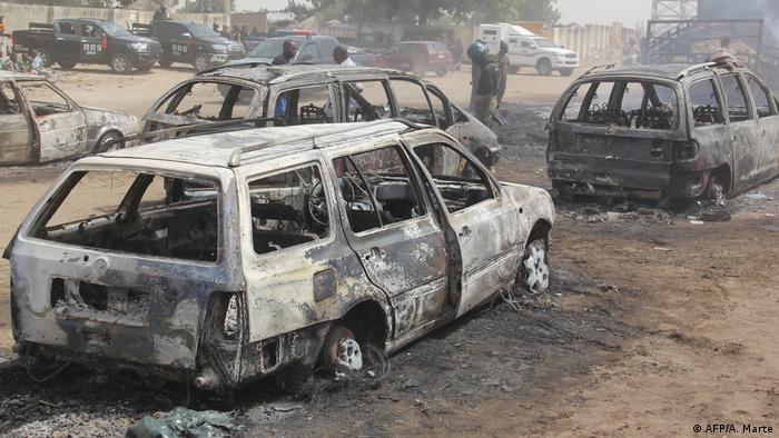 Burnt out cars line the road after an attack