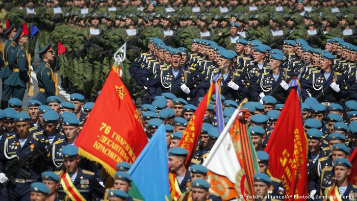 Russian soldiers march in formation as they head to Red Square for a Victory Day military parade 