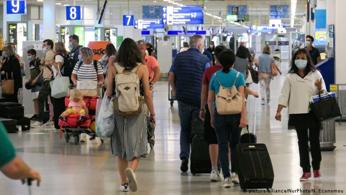 Passengers seen with the obligatory face masks at Athens International Airport in mid-June