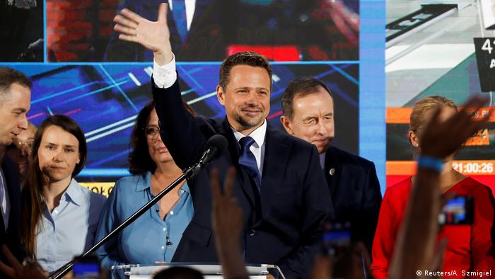Warsaw Mayor Rafal Trzaskowski waves after the announcement of the first exit poll