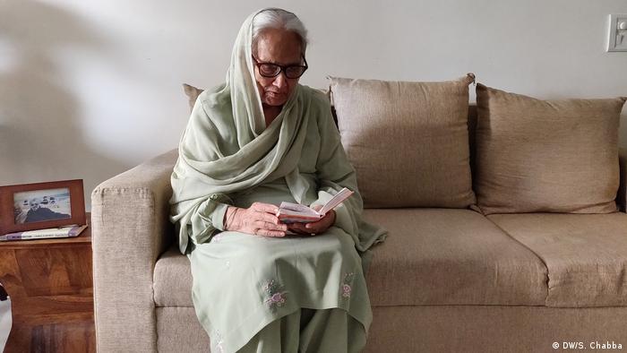 Charanjeet Kaur sits in her living room for her afternoon prayers. Her residential complex has been a containment zone as India struggles to deal with the pandemic