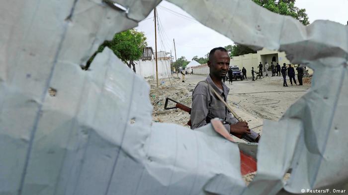 An armed Somali watches after an attack by al-Shabab (Reuters/F. Omar)