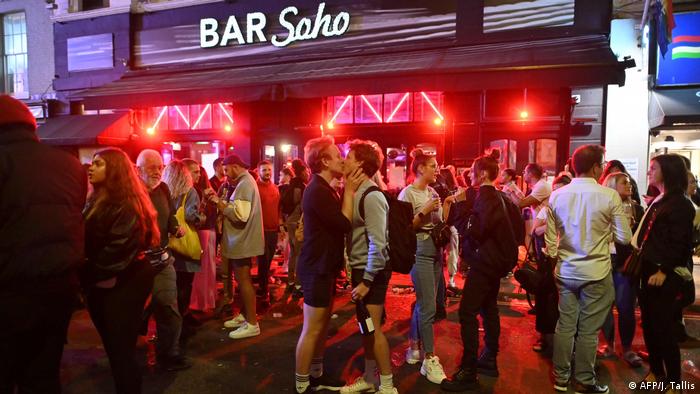 Revellers drink outside a bar in the Soho area of London (AFP/J. Tallis)