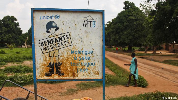 A roadside sign in Bossangoa advocates against using children in armed groups. (Jack Losh)