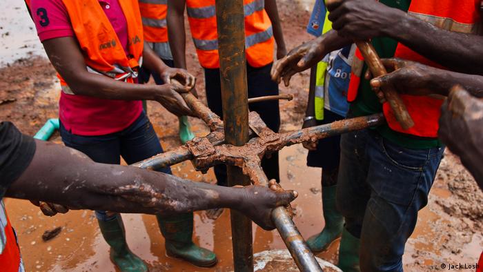 A team of former child soldiers finish drilling their new well in Bangui (Jack Losh)