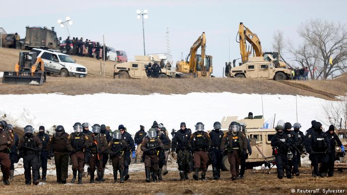 Law enforcement officers advance into the main opposition camp against the Dakota Access oil pipeline near Cannon Ball, North Dakota, U.S., February 23, 2017. (Reuters/T. Sylvester)