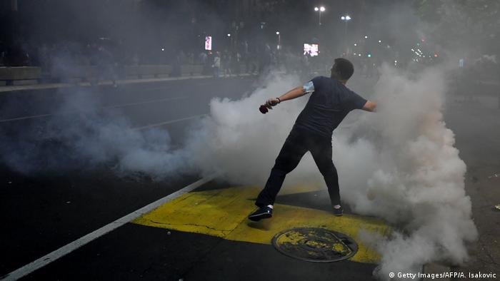 Protesters holds up a tear gas canister (Getty Images/AFP/A. Isakovic)