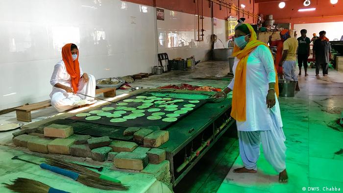 The kitchens open every day at 3a.m. to prepare meals for nearly 100,000 people. Men and women get together to cook dal (lentils), roti (Indian flatbread) and rice. Funding is provided by the Delhi Sikh Gurdwara Management Committee (DSGMC) and donations from Sikh devotees.