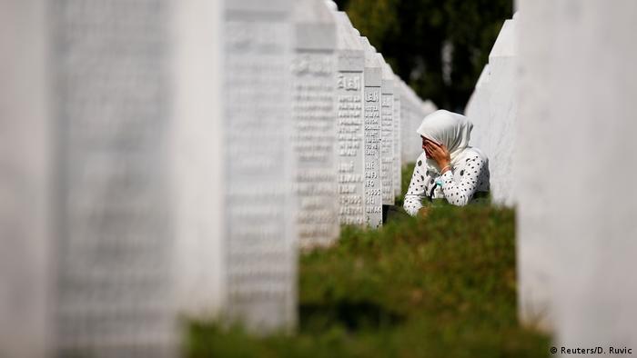A woman cries at a graveyard ahead of a funeral in Potocari near Srebrenica, Bosnia and Herzegovina as Bosnia marks the 25th anniversary of the Srebrenica massacre. 