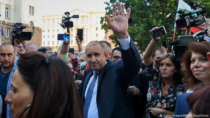 President Rumen Radev waves at the camera as he is surrounded by supporters