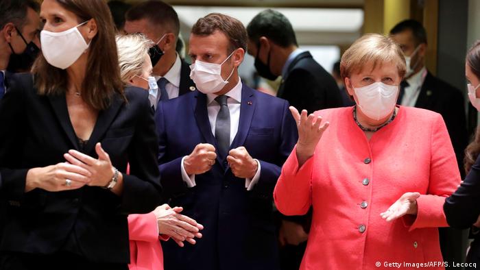 EU leaders including Sophie Wilmes, Ursula von der Leyen, Emmanuel Macron and Angela Merkel talk in a Brussels building while wearing masks (Getty Images/AFP/S. Lecocq)