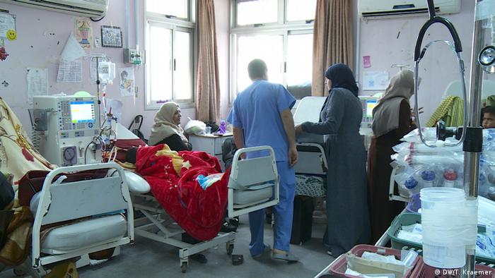 A doctor speaks to patients in a hospital ward in Gaza