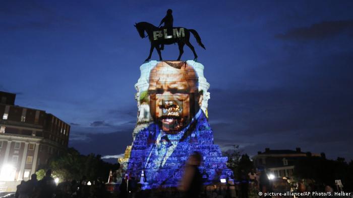 An image of the late civil rights leader and congressman John Lewis is projected onto the statue of Confederate Robert E. Lee in Richmond, Virginia