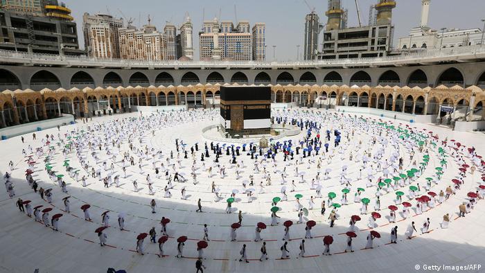 Wide shot of pilgrims circumambulating around the Kaaba, Islam's holiest shrine