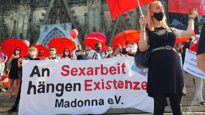 Demonstrators hold banners which read: 'Our existence depends on sex work'