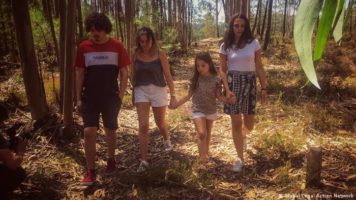 Four youth activists walk in woods in Portugal