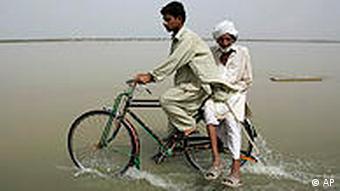 Crossing a flooded road in Punjab province on Monday